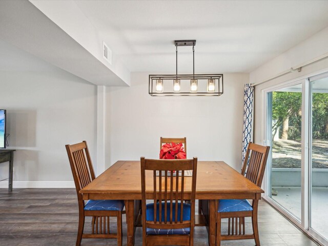 dining area with dark hardwood / wood-style floors