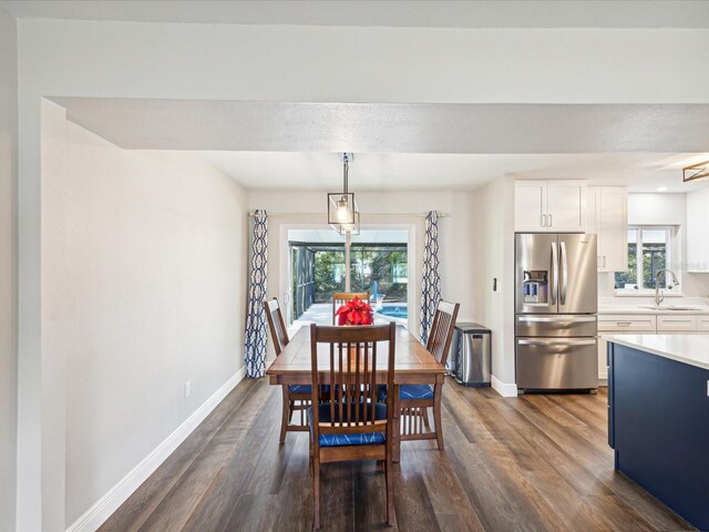 dining area featuring dark hardwood / wood-style floors and sink