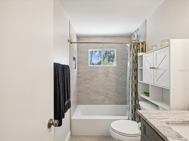 full bathroom featuring tile patterned flooring, vanity, toilet, and shower / bath combo