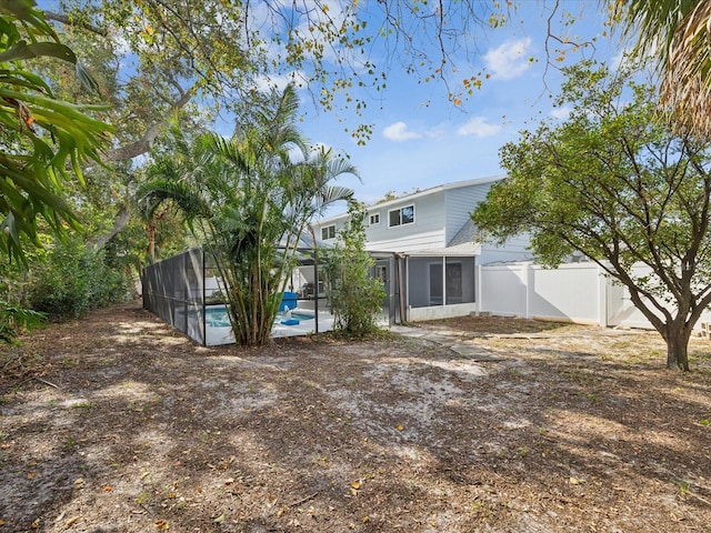 view of yard featuring a fenced in pool, a lanai, and a sunroom