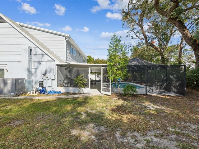 view of yard with a sunroom and a lanai