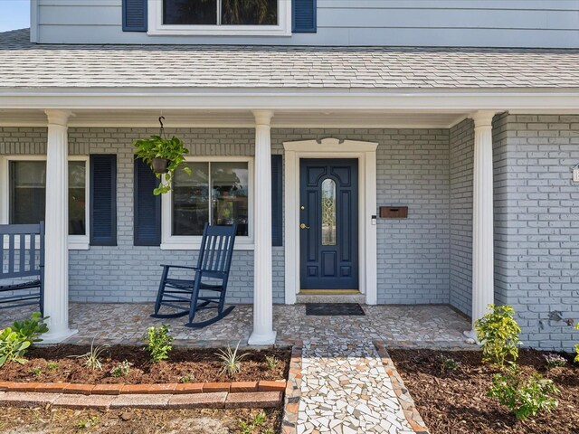 view of exterior entry with covered porch