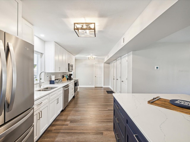 kitchen featuring dark hardwood / wood-style flooring, stainless steel appliances, white cabinetry, and sink