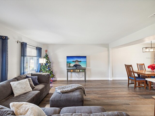 living room featuring a notable chandelier and wood-type flooring