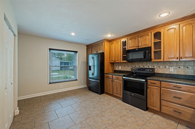 kitchen with backsplash and black appliances