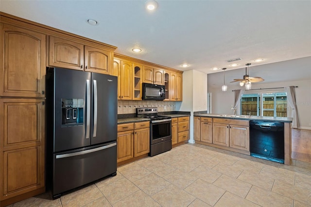 kitchen with black appliances, ceiling fan, decorative backsplash, and sink