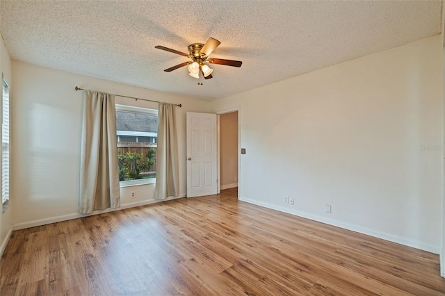 unfurnished room with light wood-type flooring, a textured ceiling, and ceiling fan