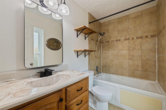 full bathroom with toilet, a textured ceiling, tile patterned floors, vanity, and tiled shower / bath