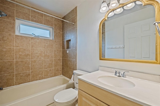 full bathroom with toilet, vanity, and tiled shower / bath