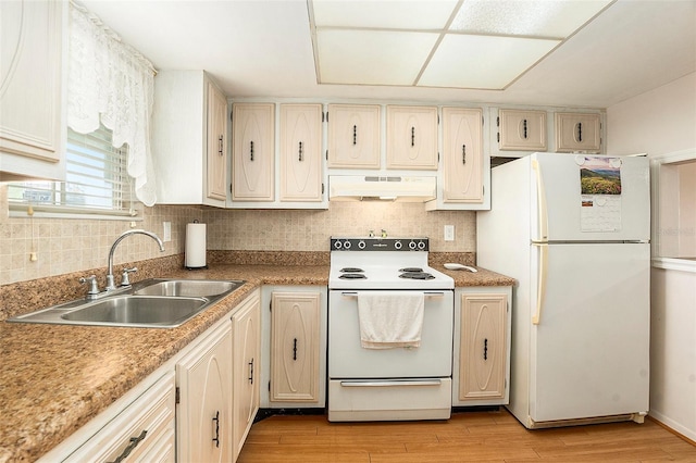 kitchen with sink, backsplash, white appliances, and light wood-type flooring