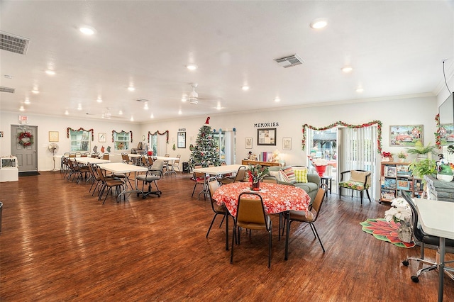 dining area featuring crown molding and dark wood-type flooring