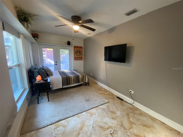 unfurnished bedroom featuring access to exterior, ceiling fan, french doors, and a textured ceiling