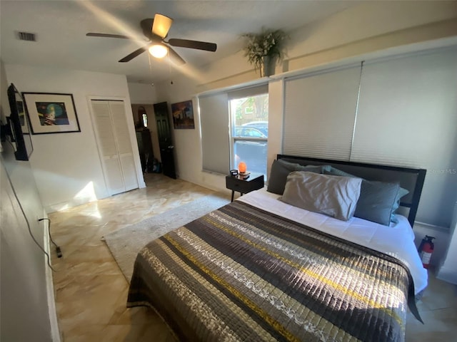 bedroom featuring ceiling fan and a closet