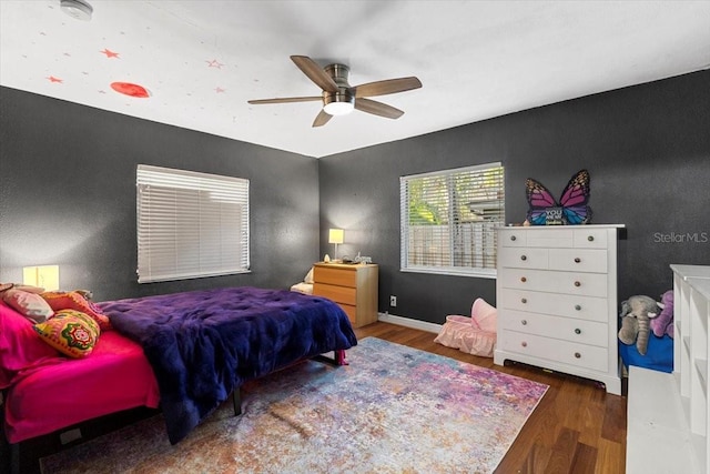 bedroom with ceiling fan and dark wood-type flooring