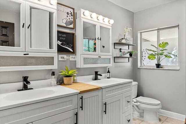 bathroom with tile patterned floors, vanity, and toilet