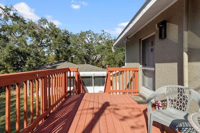 wooden terrace featuring a sunroom