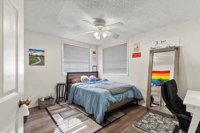 bedroom featuring ceiling fan, a textured ceiling, and hardwood / wood-style flooring