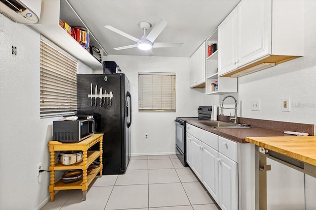 kitchen with ceiling fan, sink, light tile patterned floors, white cabinets, and black appliances