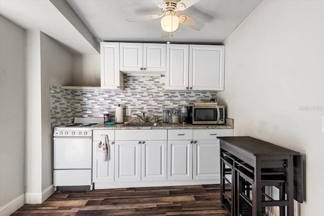 kitchen featuring white cabinetry, sink, ceiling fan, dark hardwood / wood-style flooring, and white stove