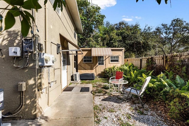 view of patio / terrace with an outbuilding and central air condition unit