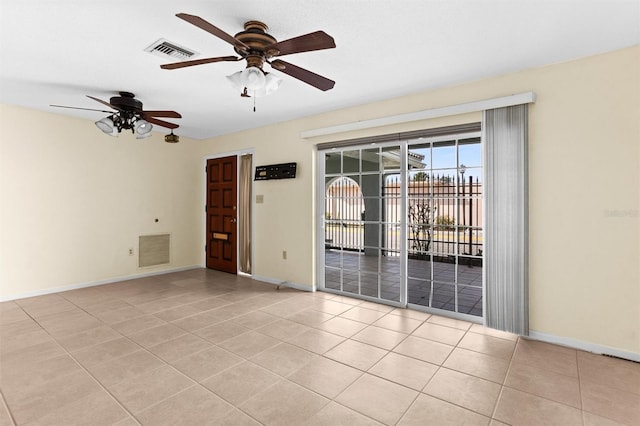 tiled empty room featuring ceiling fan