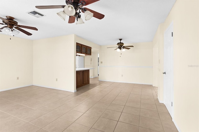 unfurnished living room featuring ceiling fan and light tile patterned flooring