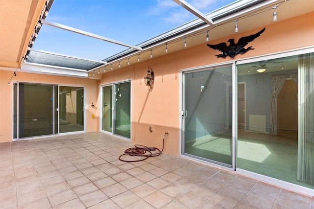 view of patio featuring a lanai