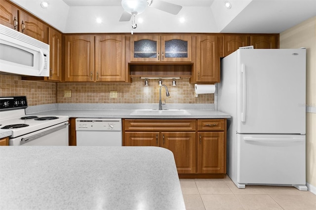 kitchen featuring white appliances, sink, light tile patterned floors, and tasteful backsplash