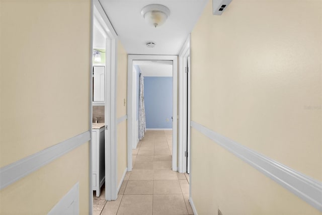 corridor with light tile patterned floors