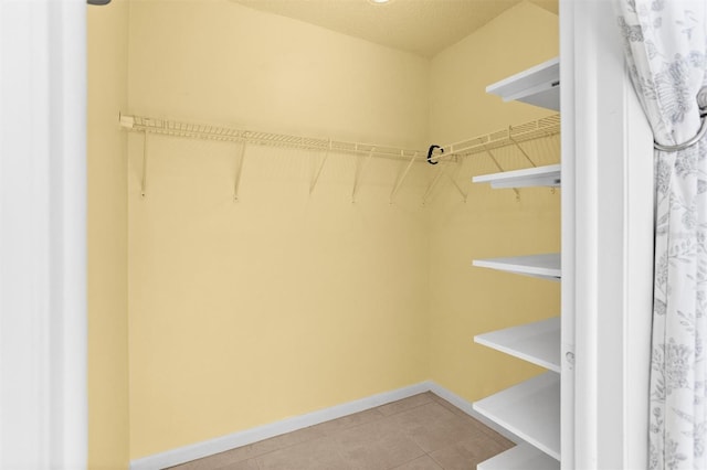 walk in closet featuring tile patterned flooring