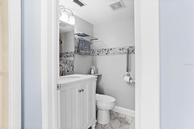 bathroom featuring vanity and toilet