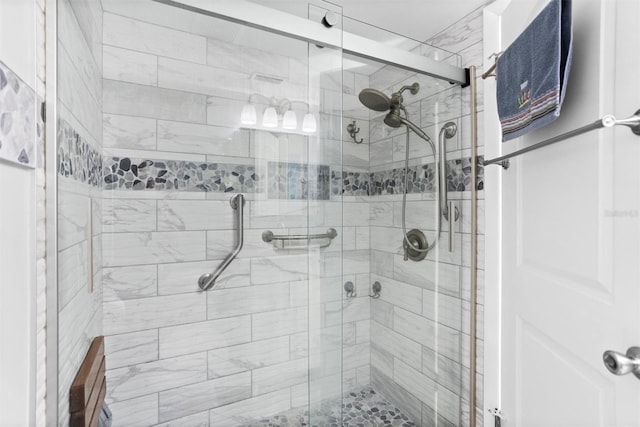 bathroom featuring a shower with door