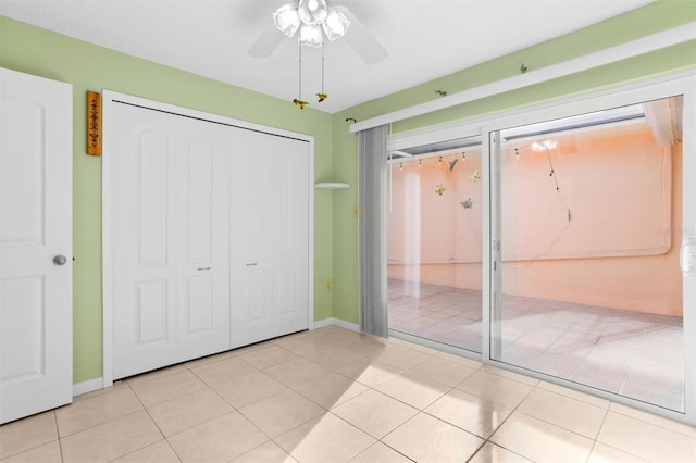 unfurnished bedroom with ceiling fan and light tile patterned floors