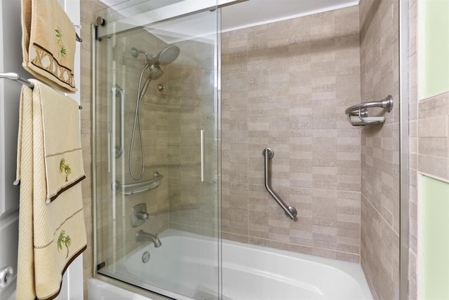 bathroom with bath / shower combo with glass door