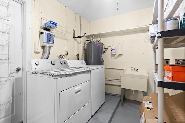 laundry area featuring washing machine and clothes dryer, sink, and water heater