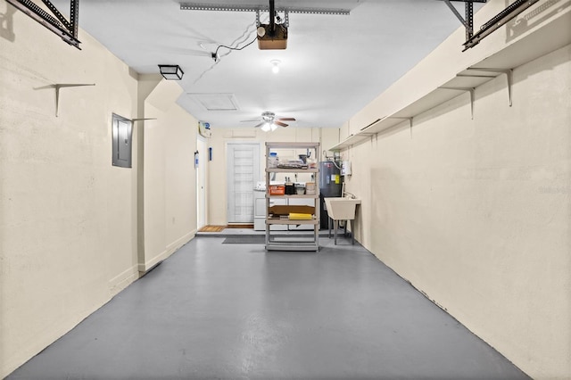 garage featuring electric panel, sink, and a garage door opener