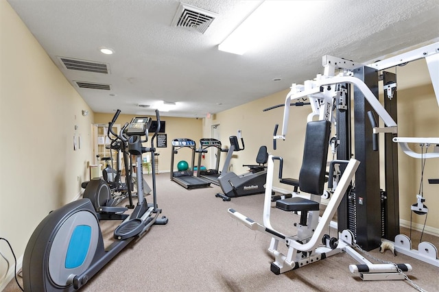 workout area featuring a textured ceiling