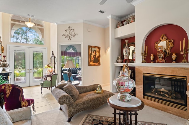 living area featuring french doors, crown molding, ceiling fan, a towering ceiling, and light tile patterned flooring