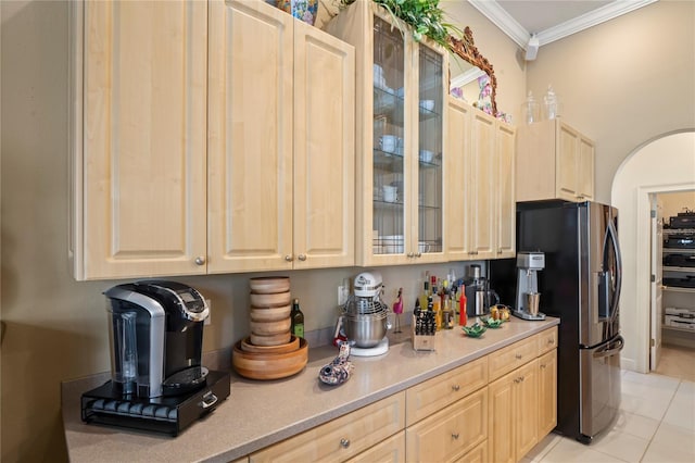 kitchen featuring stainless steel fridge with ice dispenser, light brown cabinetry, ornamental molding, and light tile patterned flooring