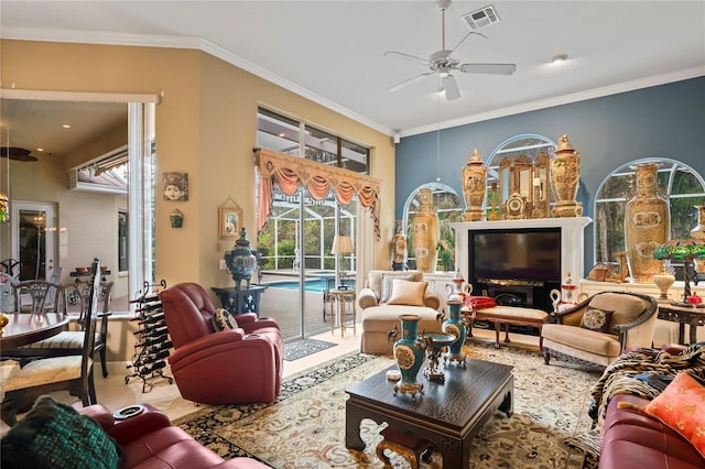 living room with ceiling fan and crown molding