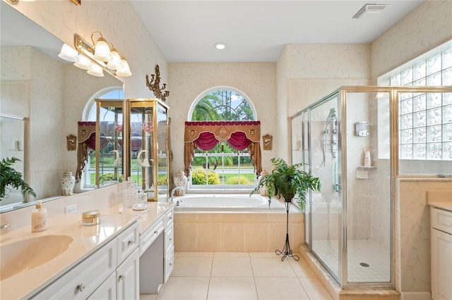 bathroom featuring tile patterned flooring, vanity, and shower with separate bathtub