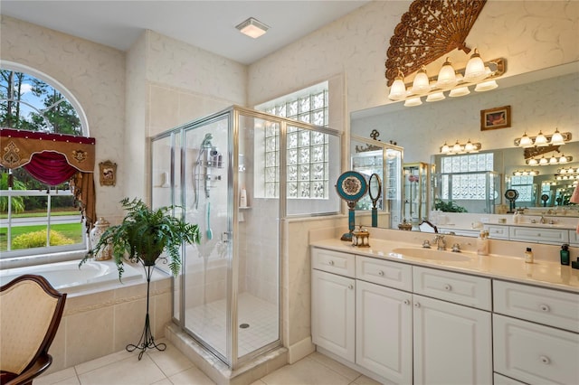 bathroom with tile patterned floors and a healthy amount of sunlight