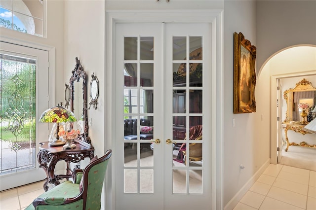 entryway featuring french doors and light tile patterned floors