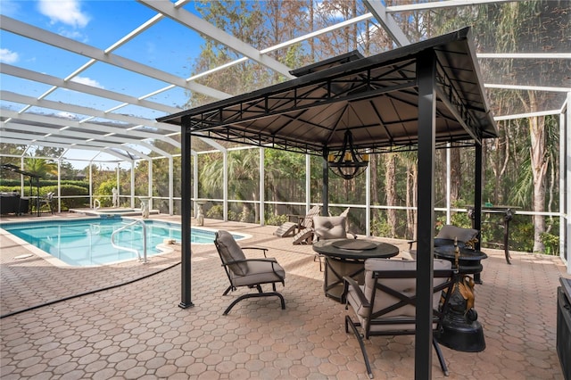 view of swimming pool featuring a lanai and a patio