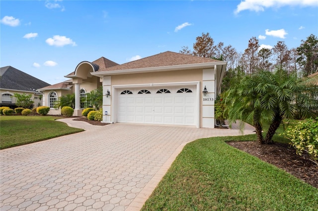 view of front facade with a garage and a front yard