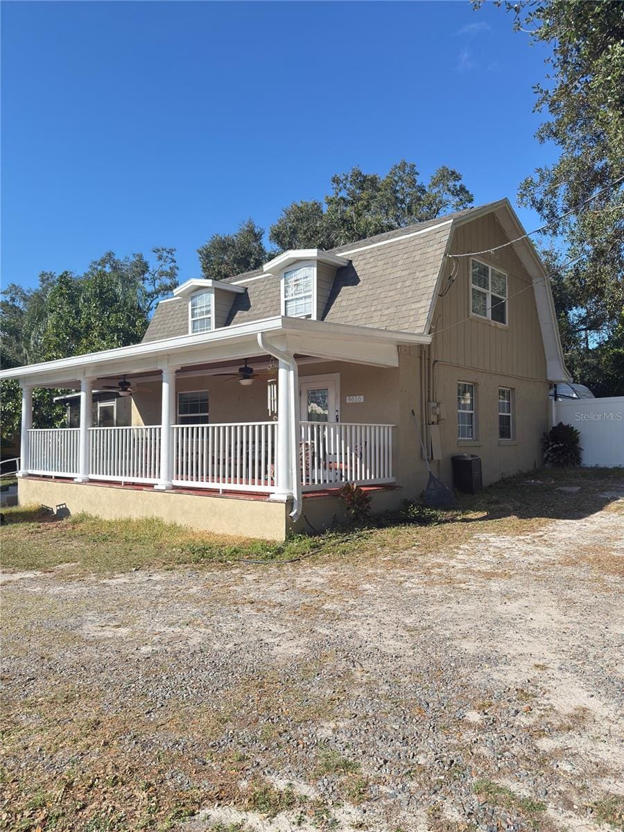 view of front of home featuring cooling unit and a porch