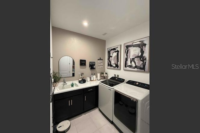 kitchen with washer and clothes dryer, sink, and light tile patterned floors