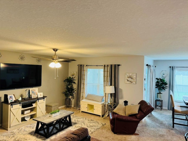 carpeted living room featuring a textured ceiling and ceiling fan