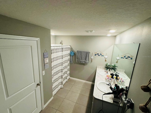 bathroom with vanity, a textured ceiling, tile patterned floors, and a shower with shower curtain