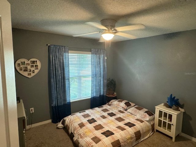 carpeted bedroom featuring a textured ceiling and ceiling fan